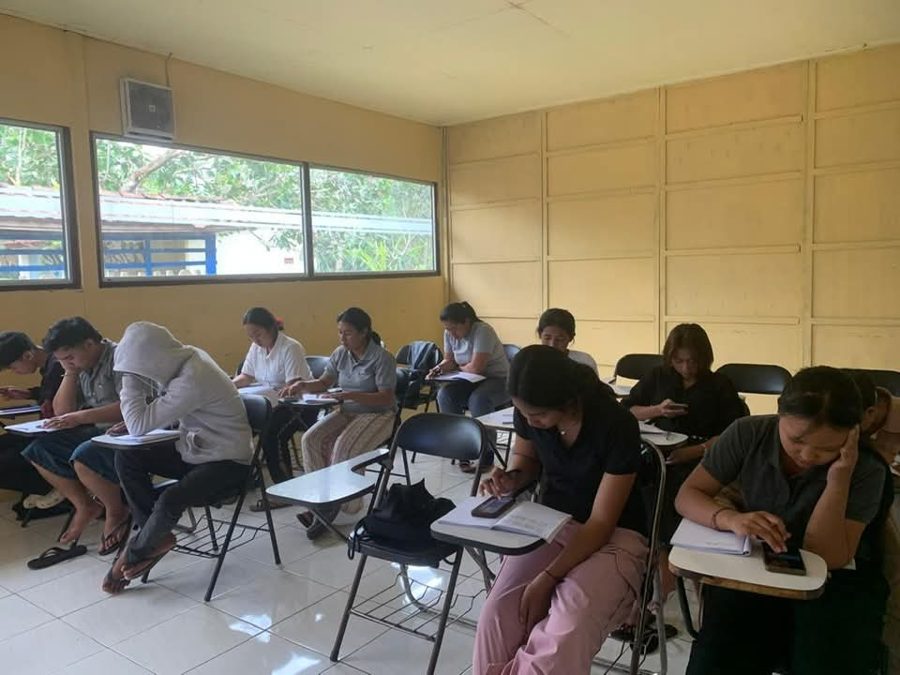 Adult students sitting a certificate exam in a classroom