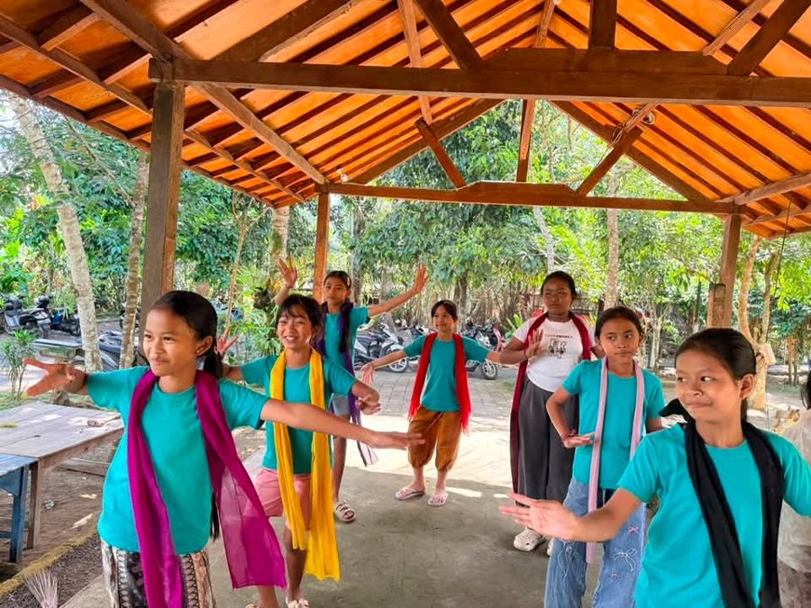 Students in mid-movement during a traditional Balinese dance lesson