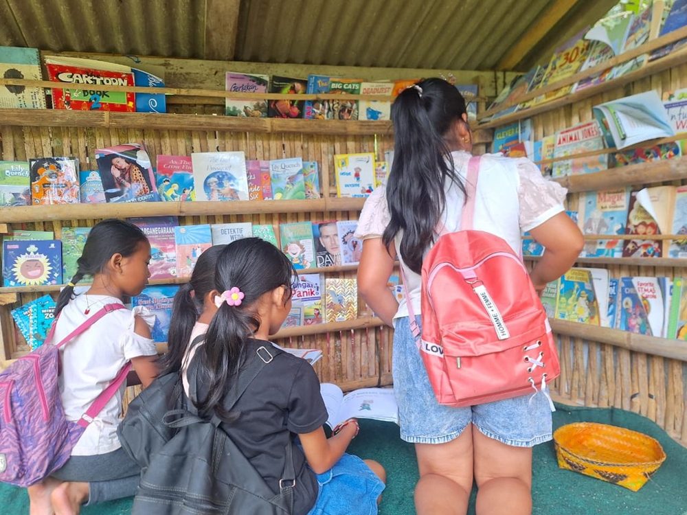Students browsing books inside the reading corner